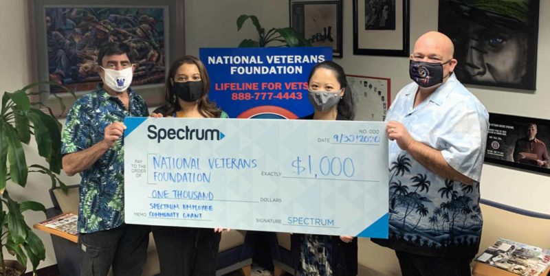 photo of Spectrum employees presenting check to Shad Meshad